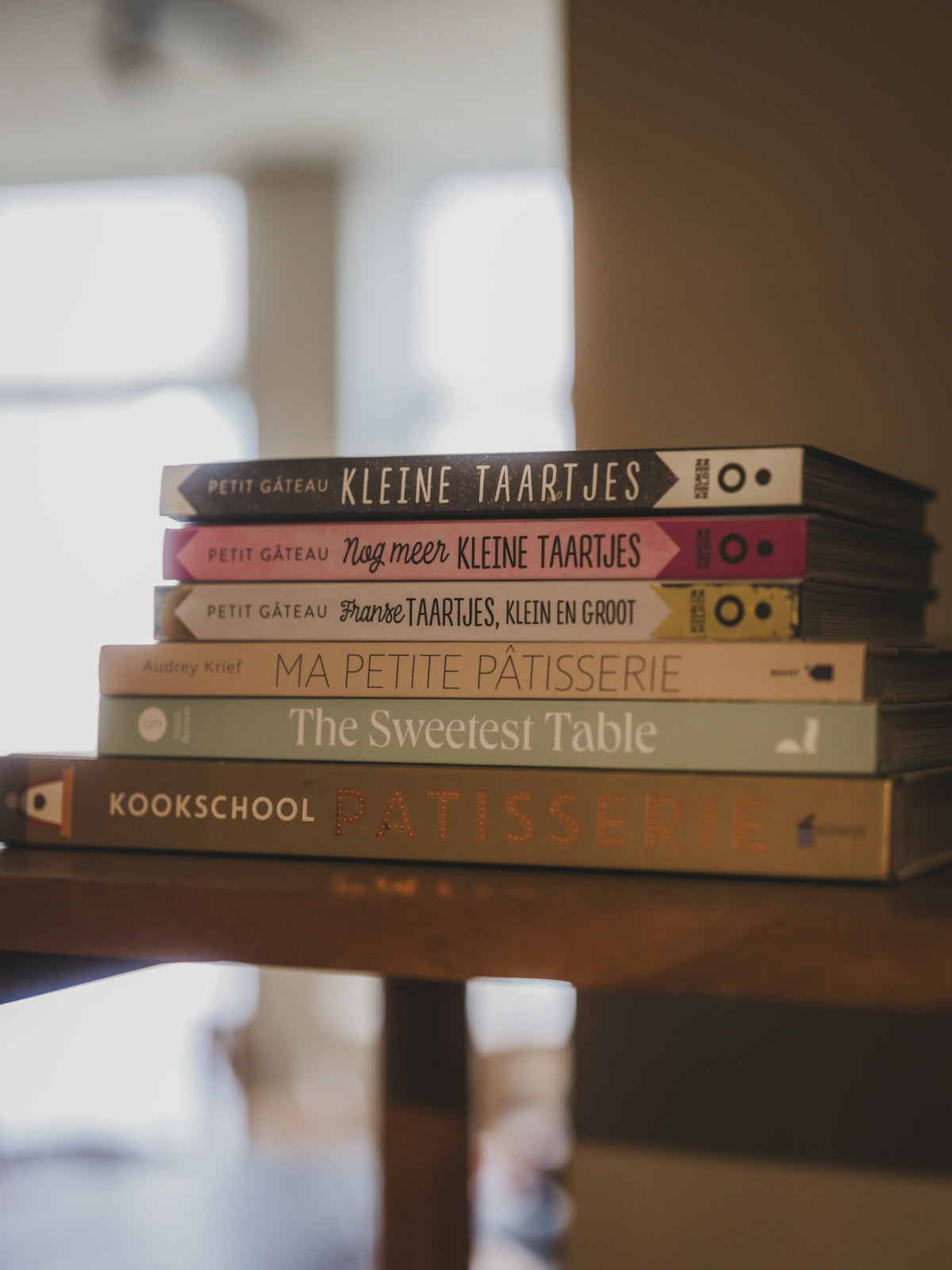 Stack of cookbooks with titles in dutch and french